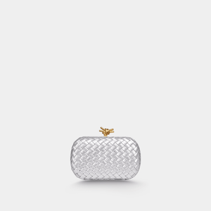 Silver woven handbag with a gold clasp on a white background
