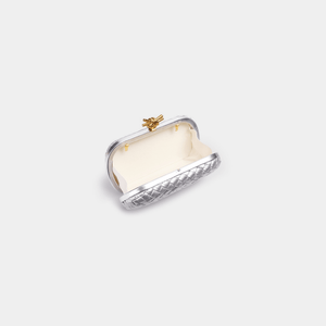 Small clutch bag with a gold clasp on a white background