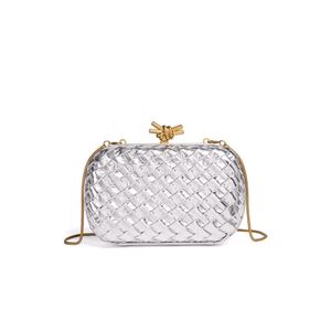 Clear woven handbag with gold accents on a white background