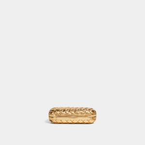 Gold ring with a textured design on a light gray background