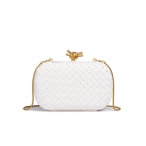 White woven handbag with a gold knot detail on a white background