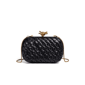 Black woven handbag with gold accents on a white background