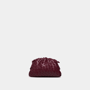 Maroon woven handbag on a light gray background
