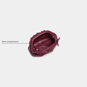 Maroon handbag with decorative patterns on a white background