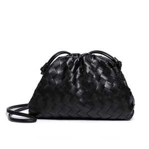 Black woven handbag on a white background