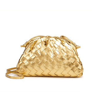 Gold woven handbag on a white background