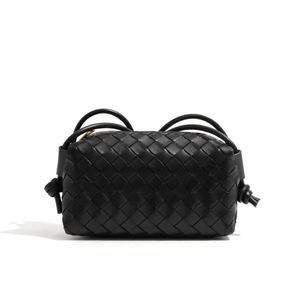 Black woven handbag on a white background