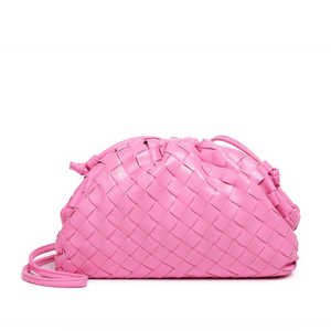 Pink woven handbag on a white background