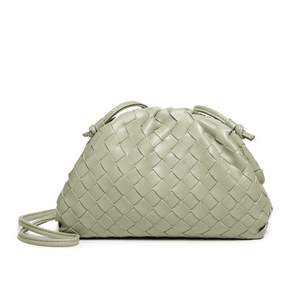 Light green woven handbag on a white background