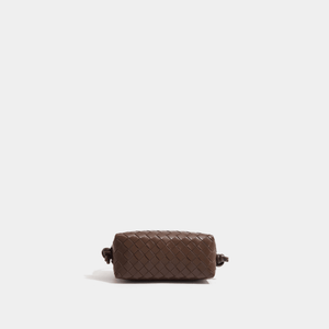 Brown woven pouch on a light beige background