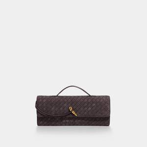 Quilted clutch bag with a gold clasp on a light gray background