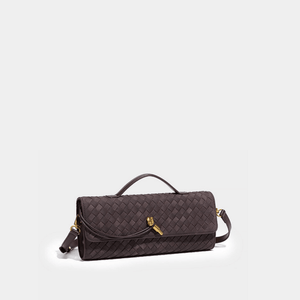 Brown quilted handbag with gold accents on a light gray background
