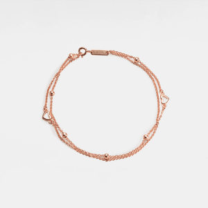 A gold-plated sterling silver bracelet with a double chain and heart-shaped beads.