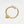 Gold bracelet with a heart-shaped tag on a white background