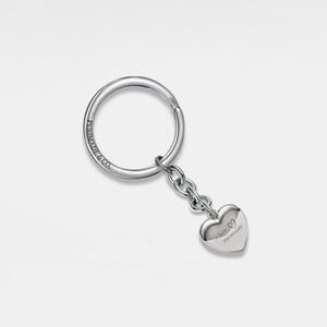 Keychain with a silver heart-shaped locket on a light gray background