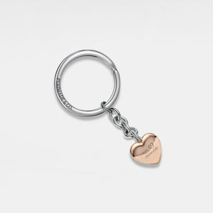 Keychain with a rose gold heart-shaped locket on a light gray background