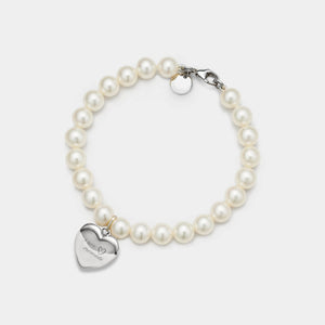 Pearl bracelet with a silver heart-shaped locket on a white background