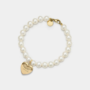 Pearl bracelet with a gold heart-shaped locket on a white background
