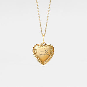 Gold heart-shaped locket with 'I love Permade' engraving on a light gray background