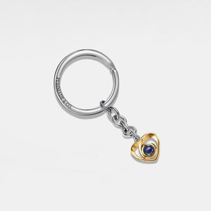 Silver keychain with a heart-shaped pendant on a light gray background