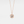 A gold-plated necklace with a heart-shaped charm, featuring a custom photo projection on the charm.