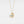 Gold heart-shaped necklace with a central gemstone on a light gray background