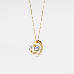 Gold heart-shaped necklace with a central gemstone on a light gray background