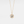 Gold necklace with a pendant featuring a central gemstone on a light gray background