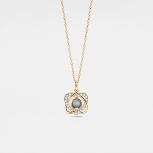 Gold necklace with a pendant featuring a central gemstone on a light gray background