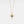 Gold heart-shaped necklace with a blue gemstone on a white background