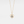 Gold heart-shaped necklace with a central pearl on a light gray background
