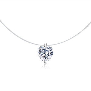 Heart-shaped crystal pendant on a thin chain against a white background