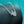 Silver necklace with a heart-shaped pendant on a textured black surface with a teal background