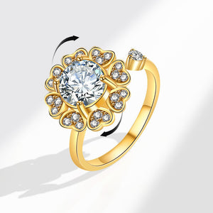 Gold ring with a large diamond and smaller stones on a white background