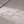 Silver bracelet with heart-shaped clasp on a light background