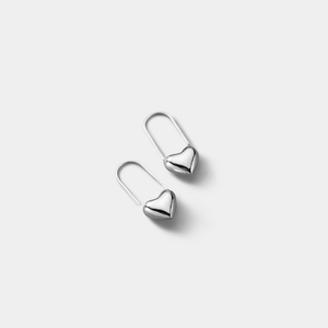 Pair of silver heart-shaped earrings on a light gray background