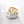 Two rings, one with a gold plating and the other with a silver plating, both featuring a heart-shaped design on the top surface.