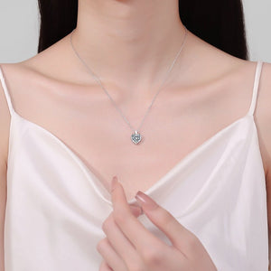 Heart-shaped necklace worn by a model in a white top