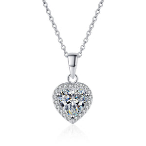 Heart-shaped diamond pendant on a chain against a white background