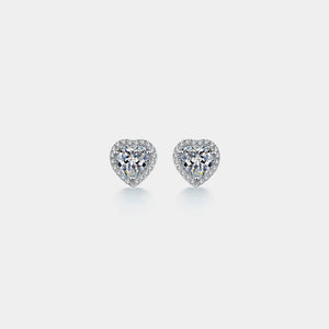 Heart-shaped diamond earrings on a light gray background
