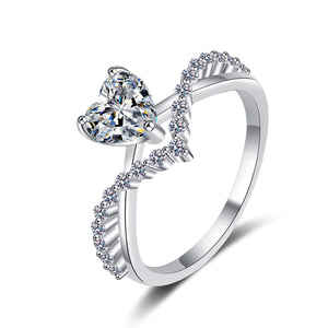 Silver ring with heart-shaped gem on a white background