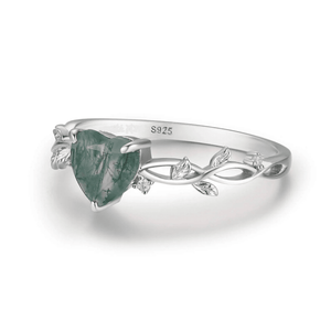 Silver ring with a green gemstone on a white background