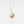 Gold heart-shaped locket pendant with paw print design on a light gray background