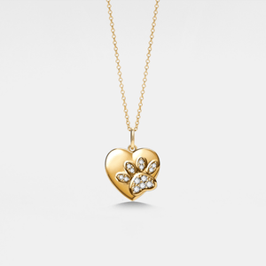 Gold heart-shaped locket pendant with a paw design on a light gray background