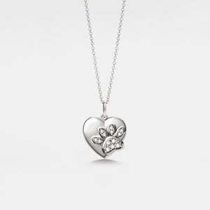 Silver heart-shaped locket pendant with a paw design on a light gray background