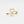 Gold ring with heart-shaped diamond on a light gray background