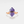 A gold-plated cocktail ring with a hexagon-shaped amethyst crystal set on a white background.