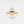 Gold ring with a geometric stone on a white background