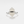 A hexagon-shaped moonstone crystal set in a gold-plated ring with a gold band.