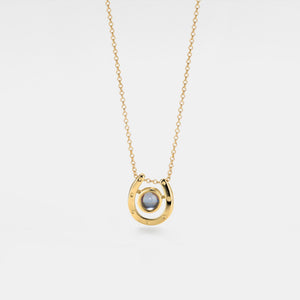 Gold necklace with a pendant on a light gray background